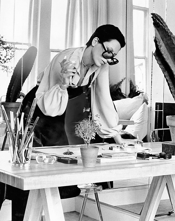 Elsa Peretti leaning over desk