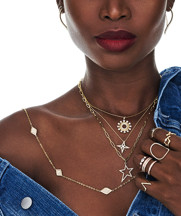 Model in denim with layered delicate necklaces