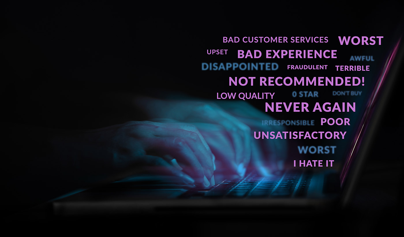 person typing bad online reviews