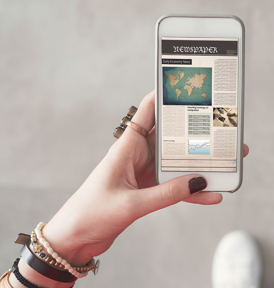 Woman holding coffee reading newspaper on smartphone