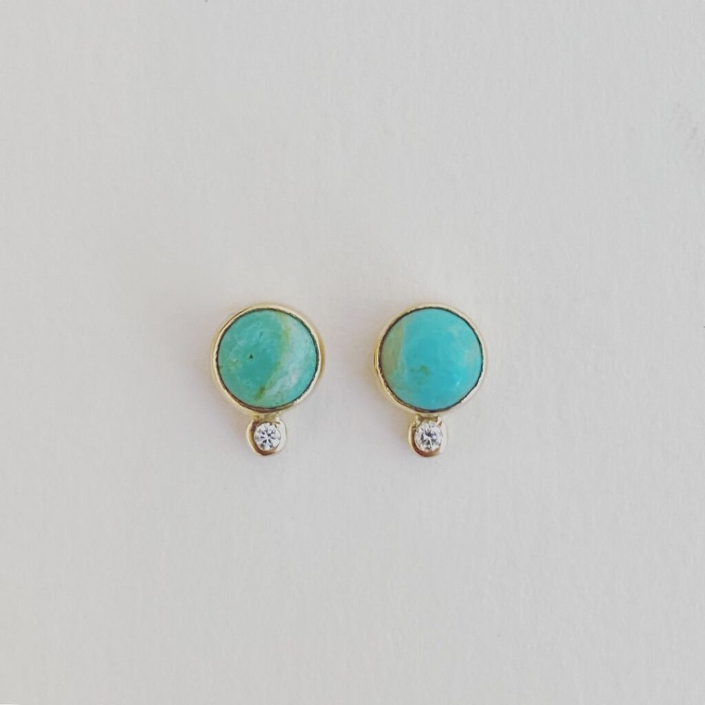 Turquoise stud earrings with a small diamond below each