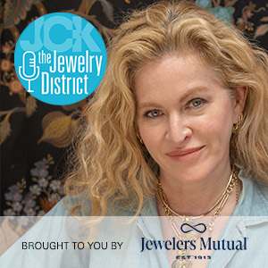 Beth Hutchens smiles with The Jewelry District and Jewelers Mutual logos.